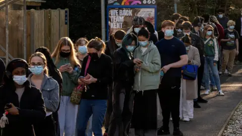 Reuters People queue to receive vaccinations at the sports centre on the University of Kent campus, following an outbreak of meningitis cases in Kent in Canterbury (file photo from 18 March)