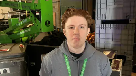 Photograph of sound Ryan Kerrigan from Eccles. He is pictured backstage at the Aviva Studios in Manchester.