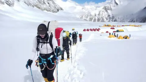 Members of an expedition team head to Camp 2 from Camp 1 during their rotation trip in the Solukhumbu district early in May