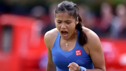 Emma Raducanu celebrates reaching the quarter-finals at Queen's by clenching her fist and shouting towards the floor
