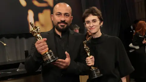 Getty Images Hamdan Ballal and Rachel Szor, winners of the Best Documentary Feature Film for "No Other Land", attend the 97th Annual Oscars Governors Ball at Ovation Hollywood Complex on March 02, 2025