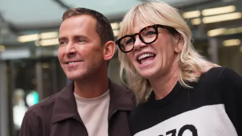 PA Media Scott Mills and Zoe Ball outside New Broadcasting House