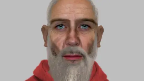 A police e-fit image of a man with short white hair and a long white beard. He has light blue eyes and prominent jaw bones, and appears to be wearing a red/orange hooded top. 