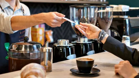 Getty Images Payment in a coffee shop