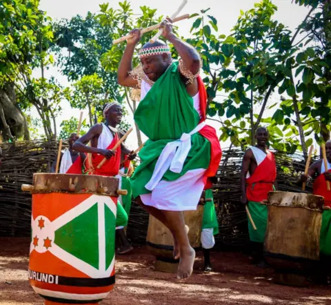 @NtareHouse Burundi's President Evariste Ndayishimiye jumping in the air as he plays the royal drums at the sanctuary in Gishora, Burundi - Wednesday 19 January 2022