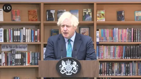 No 10 Downing Street Boris Johnson talks to pupils in library