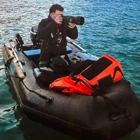 Family Photo Chris Ellery in his black boat