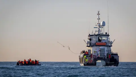 Getty Images A small boat packed with people is rescued in English waters by BF Defender operated by Border Force and overseen by HMS Severn in the middle of the English Channel on the 13th November 2022 near Folkestone Kent