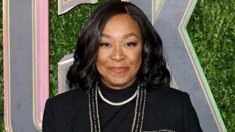 Getty Images Shonda Rhimes: Smiling in a smart black outfit 