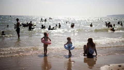 People enjoying warm weather at Camber Sands