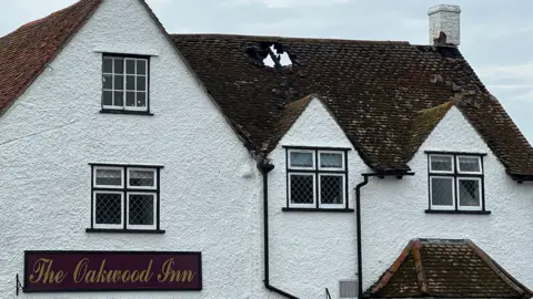 Richard Knights/BBC The damaged roof of Oakwood Inn