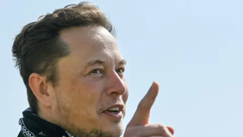 Reuters Tesla CEO Elon Musk gestures as he visits the construction site of Tesla"s Gigafactory in Gruenheide near Berlin, Germany, August 13, 2021.