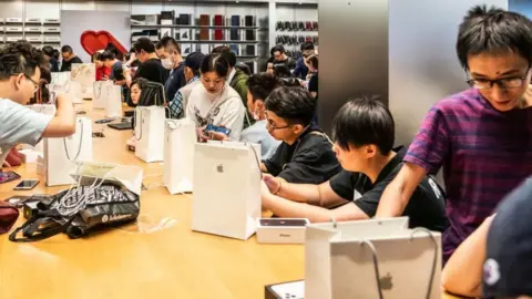 Getty Images Customers activate new iPhone 11 series smartphones after purchase at an Apple retail store on East Nanjing Road in Shanghai. Apple launched sales of its latest iPhone 11 series in China.