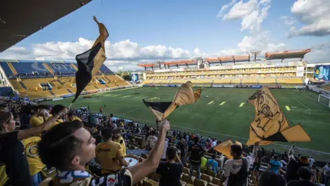AFP Fans wave flags at the Banorte stadium in Culiacan, Sinaloa State, Mexico, on September 10, 2018