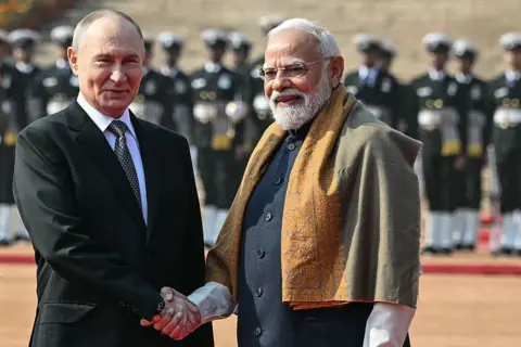 Getty Images Russian President Vladimir Putin shakes hands with India's Prime Minister Narendra Modi.