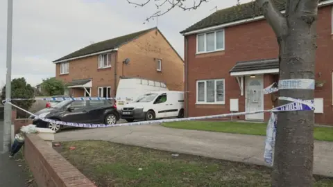 House police were called to on Cefndy Road, Rhyl, on Thursday has police tape on a tree and light pole  in front, running around the drive. 