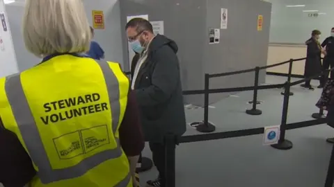 Volunteer stands in centre