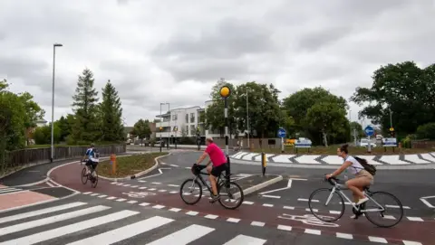 PA Media The roundabout, showing cyclists using the outer red orbital path