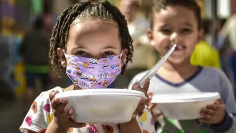 Getty Images Children from the Favela Aglomerado da Serra receive donation meals on May 20,