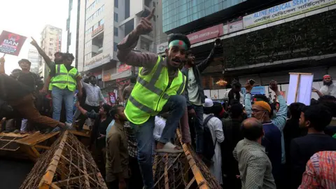 Police block the ''March to the Indian High Commission'' program in Dhaka, Bangladesh, on December 17, 2025. The program is organized to demand the repatriation of former Prime Minister Sheikh Hasina, who is ousted from power following the student and public uprising after the July massacre, and others allegedly involved in the killings who are currently staying in India. The protest also condemns ongoing conspiracies by Indian proxies, political parties, media outlets, and government officials. 