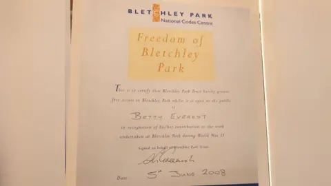 Family handout  A letter from Bletchley Park to Betty. The card reads: "This is to certify that Bletchley Park Trust hereby grants free access to Bletchley Park while it is open to the public to Betty Everest in recognition of her contribution to the work undertaken at Bletchley Park during World War II." 
