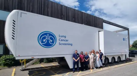 East Kent Hospitals University NHS Foundation Trust Lung Cancer Screening Programme staff outsode the mobile scanner currently situated in Whitstable.