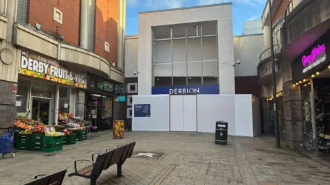Derbion sign on Albion Street. There is white board in front of it.
