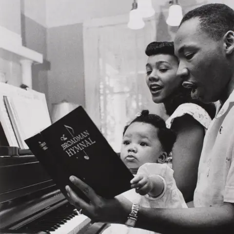 Saint Louis Art Museum Coretta Scott King, Martin Luther King and one of their children sing a hymn at the piano - Montgomery, 1956
