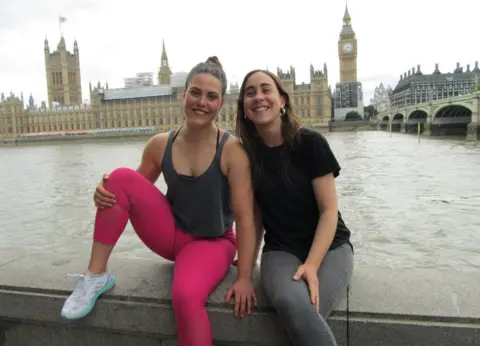 Frances Katz and Javiera Grez sitting on a wall