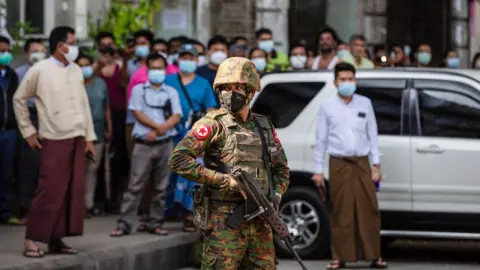 Getty Images A soldier stands guard in Yangon