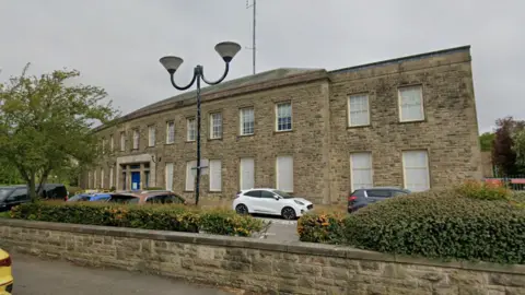 Google A police station with cars parked outside