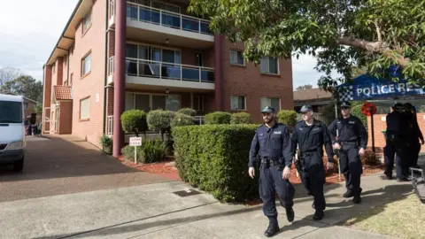 Getty Images Police outside flats in the Sydney suburb of Lakemba