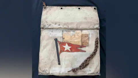 The Titanic lifeboat seat cushion, including a piece of rope.