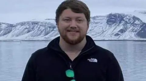 Jack Sheppard, who has short dark hair and a beard.