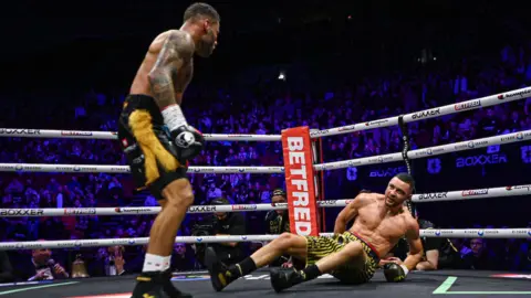 Troy Williamson knocks Callum Simpson down 