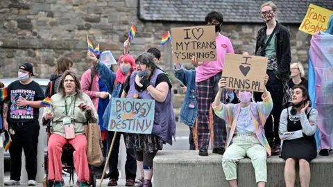 Getty Images Rally of trans rights campaigners outside the Scottish Parliament> many are holding up placards.