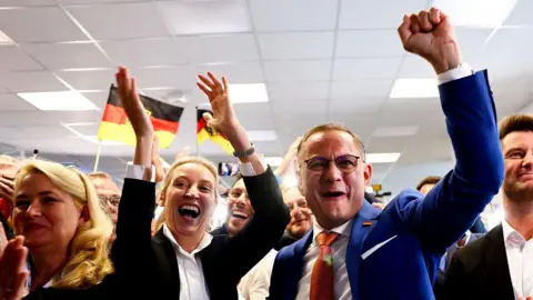 Alternative for Germany co-leaders Alice Weidel (centre) and Tino Chrupalla celebrate in Berlin, Germany. Photo: 9 June 2024