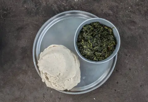 Tommy Trenchard A meal is served in the Palorinya refugee camp