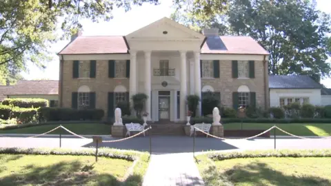 Elvis Presley's Graceland home in Tennessee. A two-story house with four columns at the porch