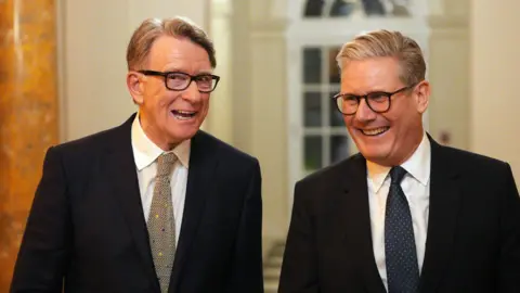 Peter Mandelson and Keir Starmer are pictured laughing wearing suits