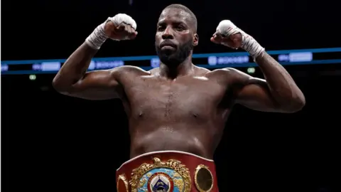 Lawrence Okolie flexes with world title