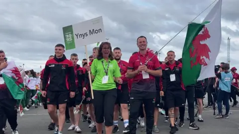 YMIGA Ynys Mon walking out at the 2023 opening ceremony in Guernsey