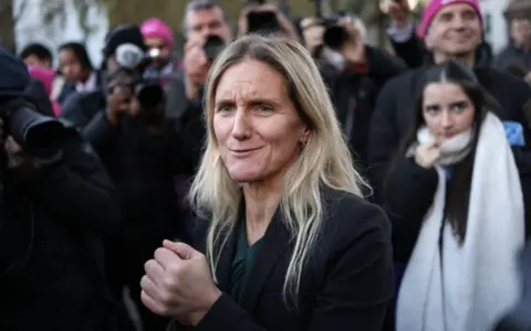 EPA Labour MP Kim Leadbeater reacts after the bill was passed in Parliament Square in London on Friday, surrounded by press and the public