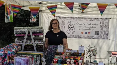 Olivia's Curiosities Person standing at a stall in a street market in Braintree