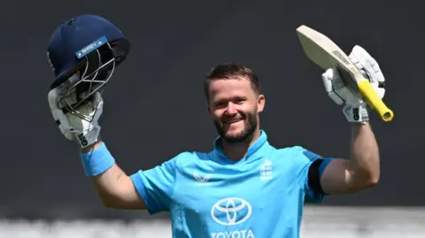 England opener Ben Duckett raises his helmet and bat to celebrate hitting a century