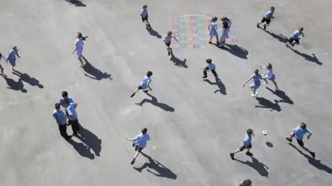 Getty Images Children playing in the sunshine