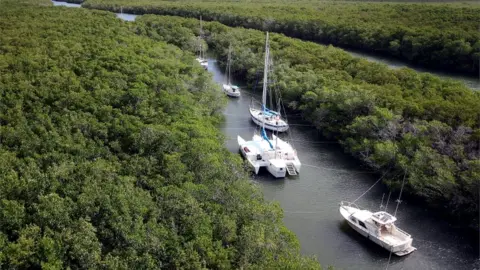 Getty Images Boats seen tied up as storm is incoming
