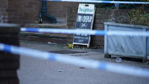 PA Media Crime scene tape and evidence markers at the Lighthouse pub