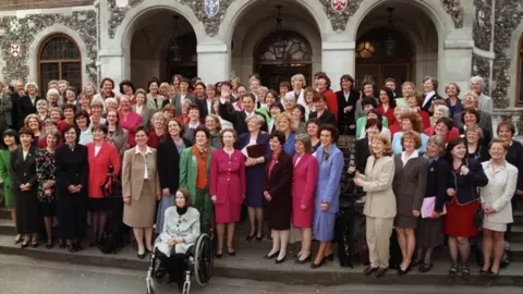 PA Tony Blair surrounded by his 101 women MPs in Westminster 1997