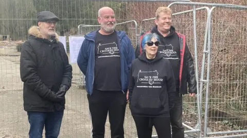 A group of campaigners standing outside the site of the pub
